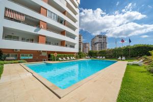 Sunlit Poolside Retreat w Balcony by HostWise