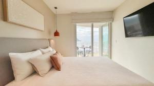 Serene and Modern Beachfront Condo with Ocean Views