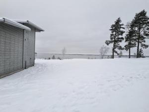 Modern, lakeside cottage with a glimpse of Lake Vänern
