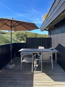 Wooden House In The Dunes Close To The Sea