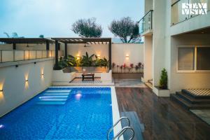 StayVista at Oriana Palms with Wifi and Pool