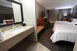 Queen Room with Two Queen Beds and Sofa Bed room in Best Western Plus CottonTree Inn
