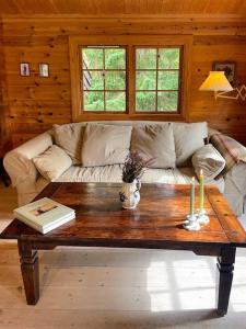 Norwegian Log Cabin Among Heather And Pine Trees