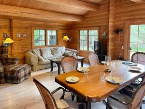 Norwegian Log Cabin Among Heather And Pine Trees