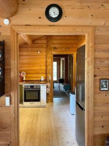 Norwegian Log Cabin Among Heather And Pine Trees