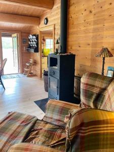 Norwegian Log Cabin Among Heather And Pine Trees