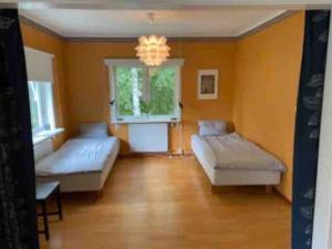 Lakefront house with beach, jetty, and rowing boat