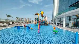Vogue Vacation Homes, Novotel Residences JVT near Springs Souk Mall, One Bedroom apartment with Balcony and Vibrant Community View, Access toAmenities