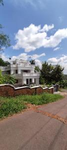 A CLASS King bedroom with balcony view, extra bed, and a spacious bathroom with changing area