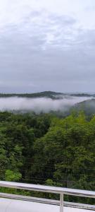 A CLASS King bedroom with balcony view, extra bed, and a spacious bathroom with changing area