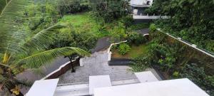 A CLASS King bedroom with balcony view, extra bed, and a spacious bathroom with changing area