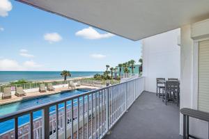 Ground floor direct oceanfront 22 with a balcony, heated pool, and garage parking