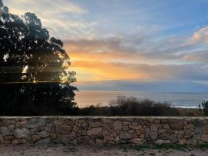 Tiny house with sunset over the ocean