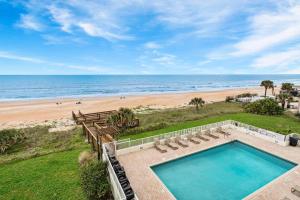 Direct oceanfront 22 condo with a private balcony, heated beachfront pool, and garage