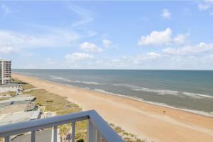 Updated direct oceanfront corner 22 with stunning beach views, a heated pool, and parking garage