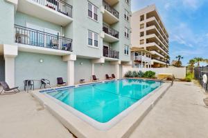 Modern oceanfront condo with outdoor pool, balcony, & washerdryer