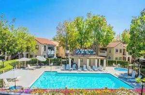 Poolside 2BR Condo with Balcony & Workspace