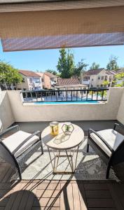Poolside 2BR Condo with Balcony & Workspace
