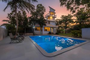 StayVista's Santoni Farms - Riverside Bliss with Pool, Orchard & Activities