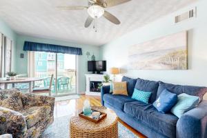 Condo near the beach with pool, BBQ area, balcony, & fireplace