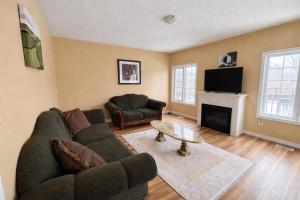 Private Queen Bedroom with Walk-In Closet, TV & Mini Fridge in Brampton Shared Home - 3 Baths, Full Kitchen, WiFi, Laundry & Deck - Near GO Station, Ideal for Work & Study!