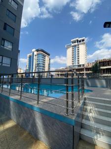 modern serenity suites apartments with swimming pool,modern equipped gym,private parking space, children playing ground, proximity to major shopping malls and unbeatable city views