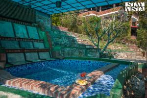 StayVista at Mystic Grove with shared Pool, BBQ and Bonfire