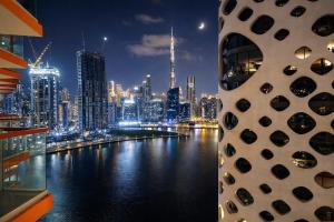 1BR Canal-Front Balcony with Burj Khalifa View - Live Luxe Dubai