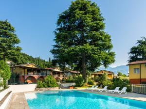 Apartment on Lake Garda with pebble beach, pier for boat, three swimming pools