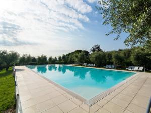 Apartment on Lake Garda with pebble beach, pier for boat, three swimming pools
