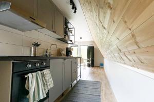 A Frame cottage surrounded by a forest