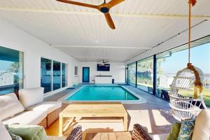 Renovated lakefront retreat with screened pool, private dock, patio, grill & WD