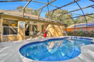 Peaceful home with an enclosed patio, pool, grill, washerdryer, & AC