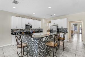Colorful home with pool, patio, kitchen, washerdryer, & game room