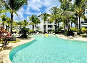 White haven surrounded by tropical gardens, pools