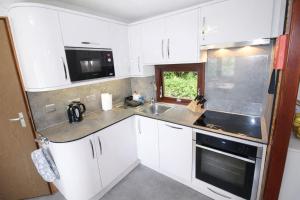 Neaum Crag Lodge ideal for a couple or family with young children in a woodland setting at Skelwith Bridge