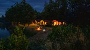 Forteca, rustykalne drewniane domki nad brzegiem stawu, łazienki współdzielone