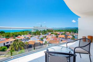 Stylish ocean-view condo with pool, gym, private balcony, AC, & WiFi
