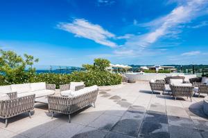 Stylish ocean-view condo with pool, gym, private balcony, AC, & WiFi
