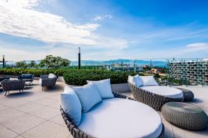 Stylish ocean-view condo with pool, gym, private balcony, AC, & WiFi