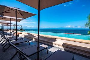 Modern waterfront condo with shared pool, balcony, and washerdryer