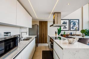 Luxury ocean-view condo with resort pool, private balcony, and washerdryer