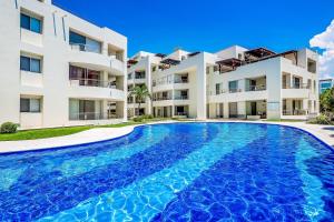 Spacious condo with near the beach with resort-style pool, inviting balcony