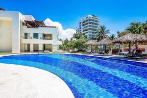 Spacious condo with near the beach with resort-style pool, inviting balcony