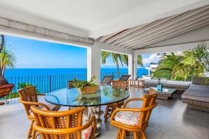 Bright ocean-view 2-story condo near beach with pool, balcony & full kitchen