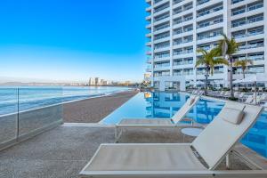 Luxury oceanfront apartment with private balcony, rooftop pool & gym access