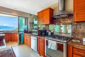 Mismaloya Beach condo with ocean views, on-site pool, grill, & private balcony