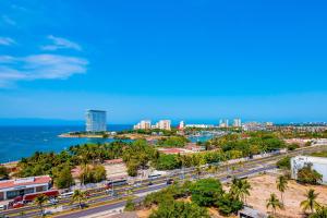 Resort condo with balcony, scenic view, rooftop pool, & well-equipped kitchen