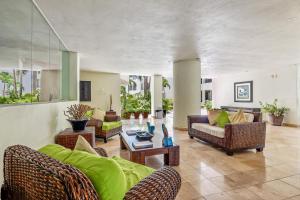 Ocean-view condo with pools, roof deck, lounge, private balcony, & AC