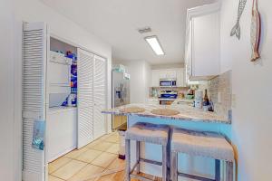 Sunlit two-story condo with pool walk one block to the beach